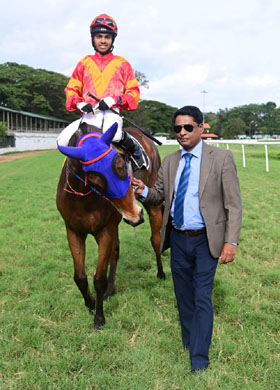 Contributor (Vivek G up) winner of the B.A.NANAIAH MEMORIAL TROPHY, being led in by trainer Bobby M on Thursday races at Mysore.