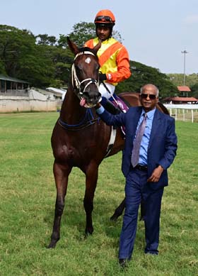 Gloriousness (Darshan R N up), winner of the MAJ.SARDAR L.MAHADEVAIAH MEMORIAL TROPHY (DIV-I), being led in by trainer S Narredu on Thursday races at Mysore.
