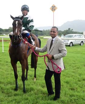 Sapient (Vinod Shinde up) winner of the BIDADI PLATE, being led in by trainer J S Pillay on Wednesday racecs at Mysore.