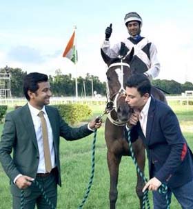 Raj Shroff plants an affectionate kiss on Heart (Trevor Patel up) after the filly won the Gr 2 Calcutta Monsoon Derby Stakes at Kolkata on Sunday. Trainer Deepesh Narredu is the other person in the picture.