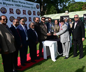 President of Karnataka Race Horse Owners Association Girish Baliga presenting the KROS Mysore 1000 Guineas Trophy to Dr Cyrus Poonawalla and S R Sanas after Tehani won this event at Mysore on Friday.